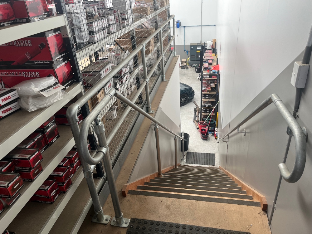 Various Interclamp handrail systems installed on a mezzanine floor to improve it's overall safety